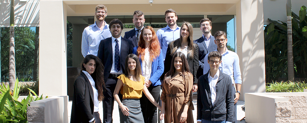 Group of twelve students standing on stairs outside of a building